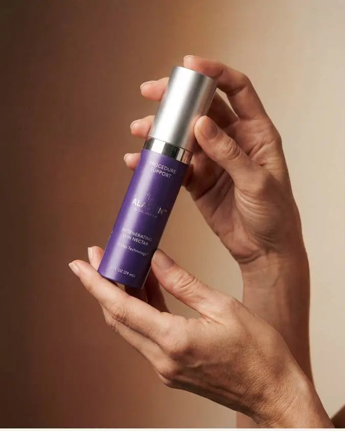 Hand hollding bottle of Alastin Skin Nectar