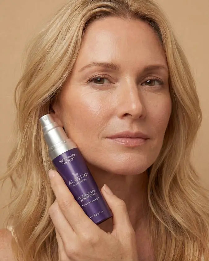 Woman holding bottle of Alastin Skin Nectar