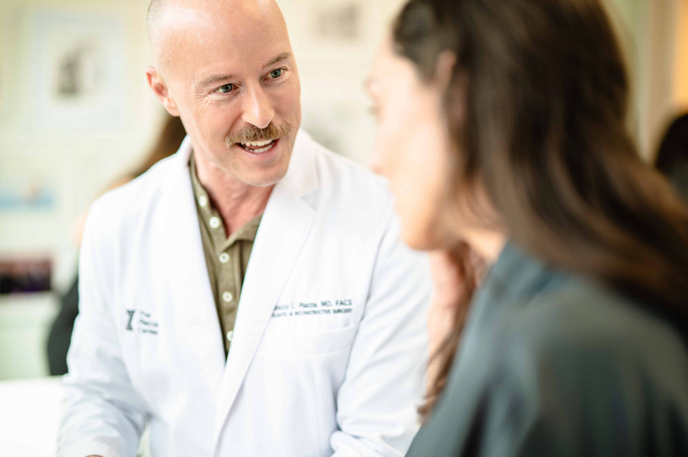 Dr. Rocco Piazza, MD, FACS, board-certified plastic surgeon, with a patient at The Piazza Center in Austin, Texas