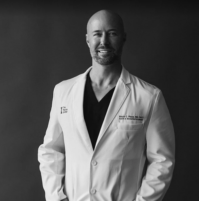 Dr. Rocco Piazza, MD, FACS, in his white coat