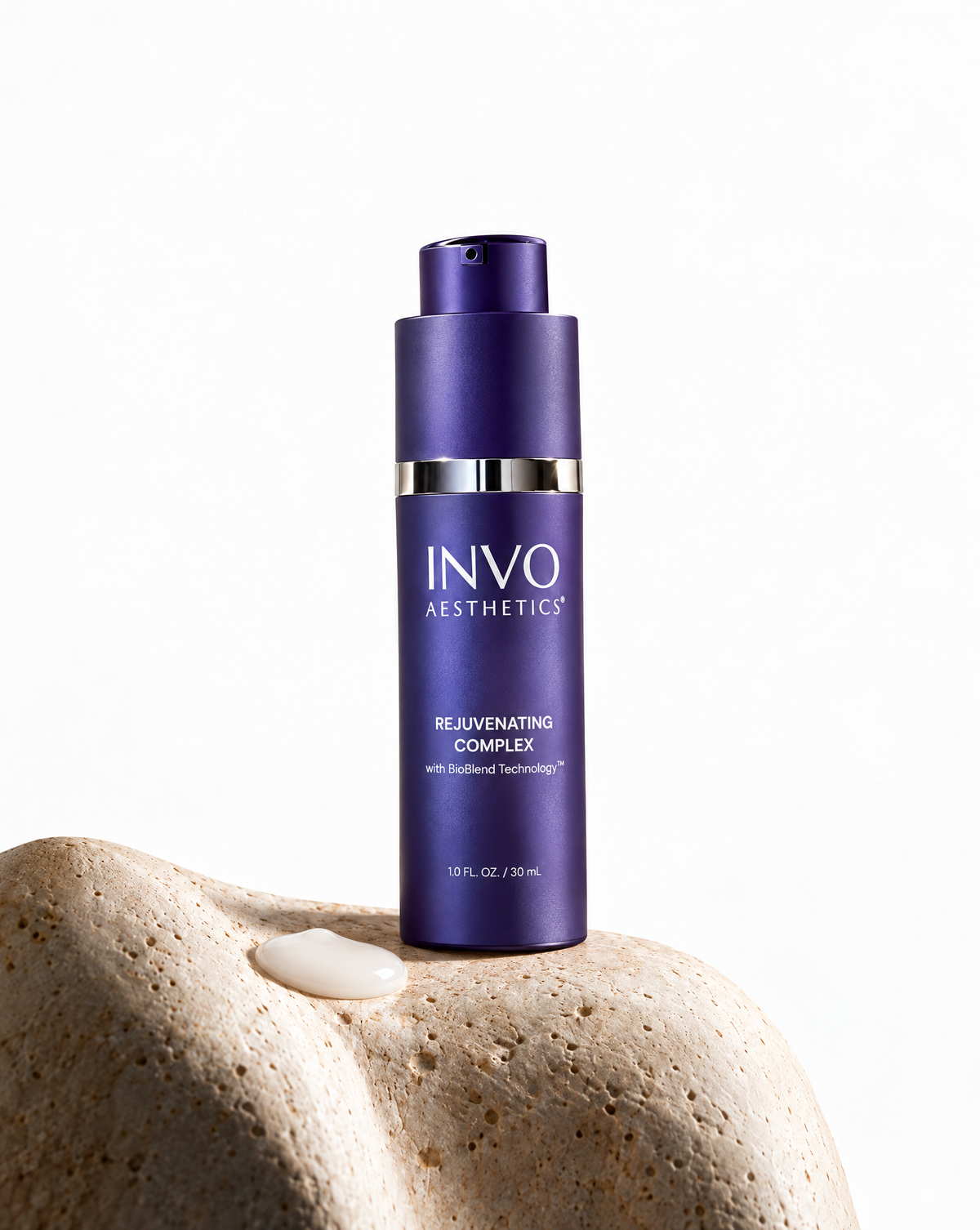 INVO Rejuvenating Complex bottle on stone with a pool of cloudy white exosome serum