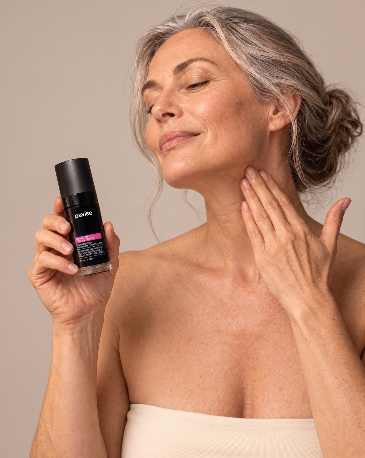 Woman applying Pavise Bioadaptive Stress Repair night serum along her jaw in a studio